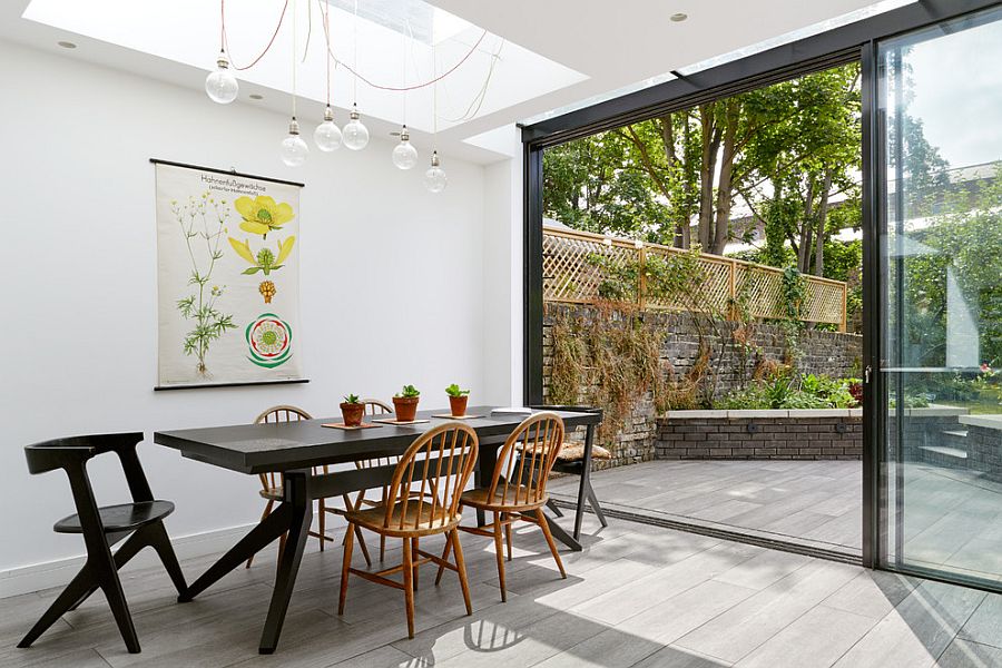 Elegant-kitchen-in-white-connected-to-the-garden-uses-botanical-art-to-bring-greenery-indoors