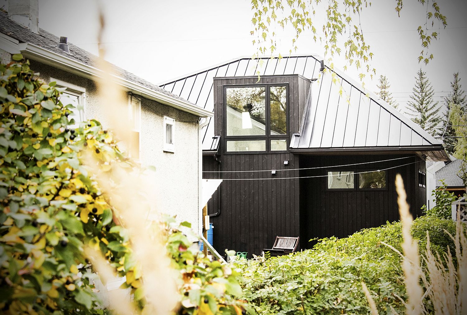 Lush green landscape and garage outside the Canadian home