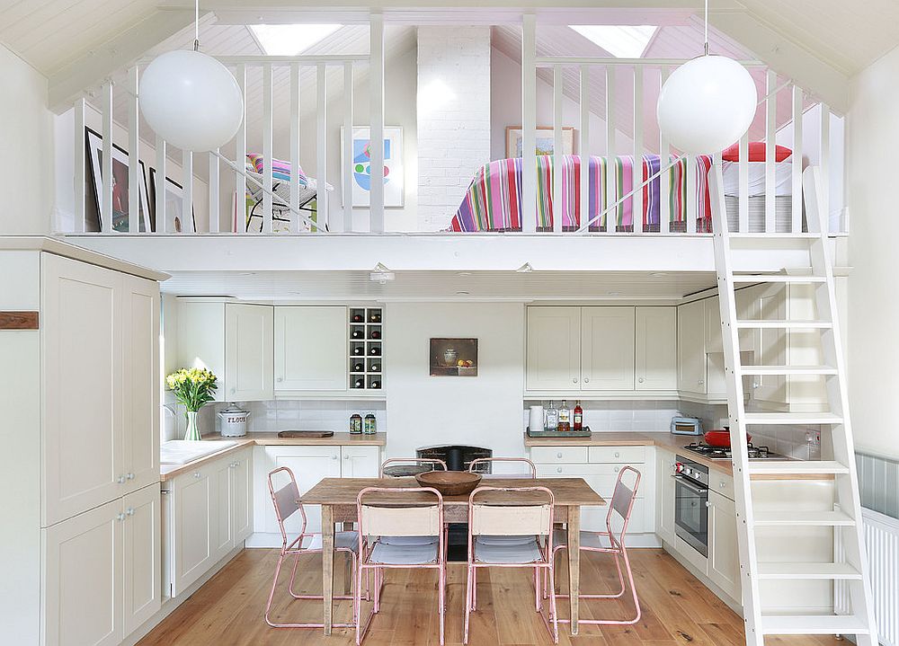 Mezzanine level above the kitchen holds a cozy sleeping space and sitting nook