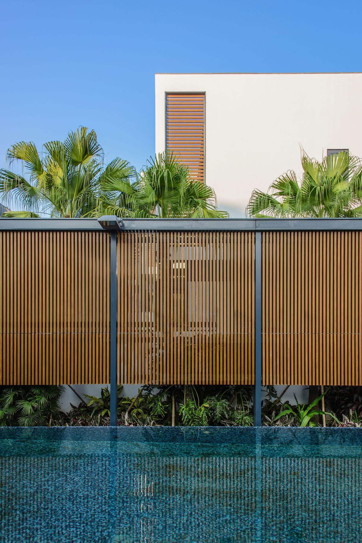 Pool area outside the villas surrounded by natural garden