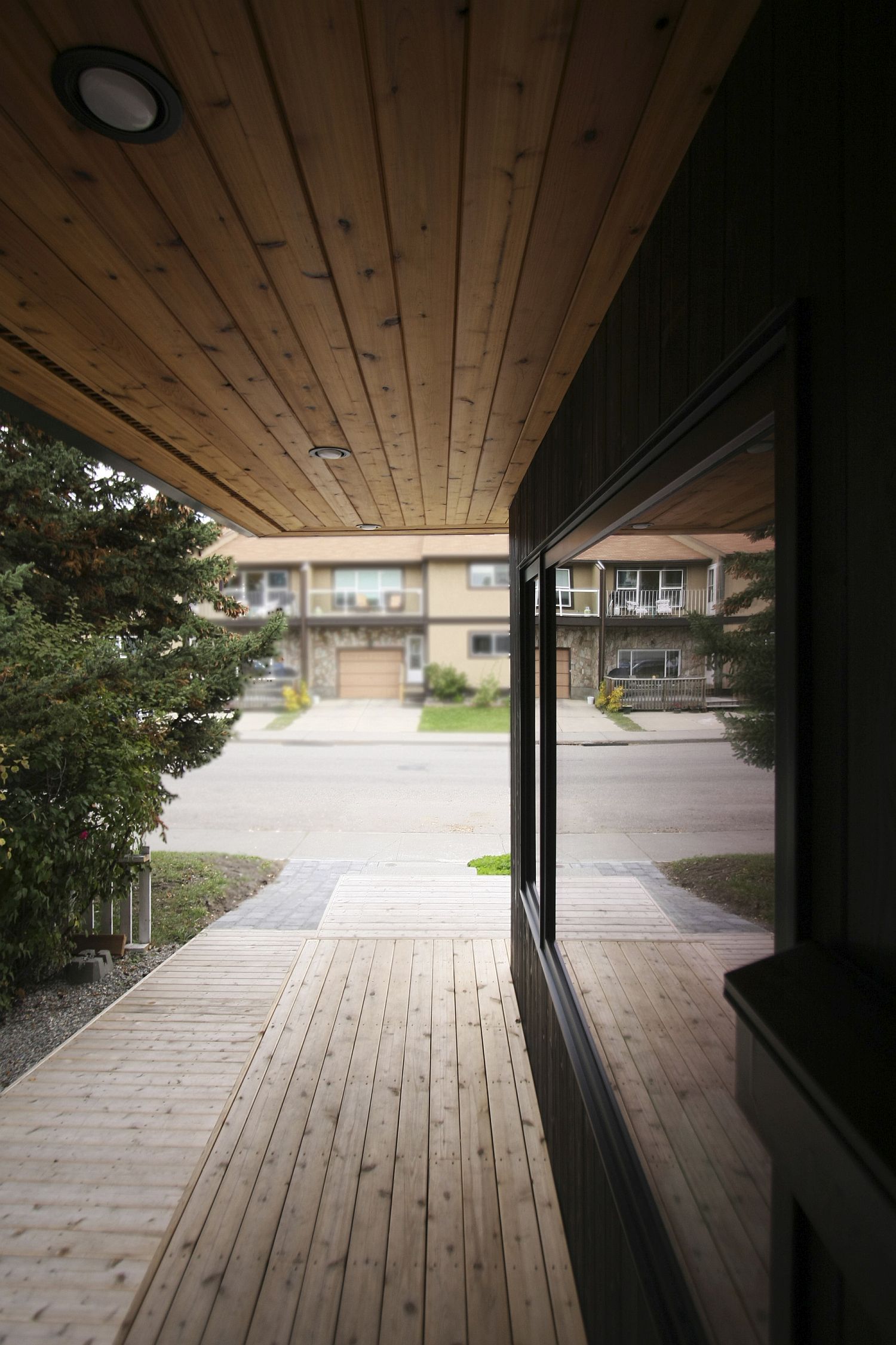 Sheltered wooden wlakway around the Hillhurst Laneway House