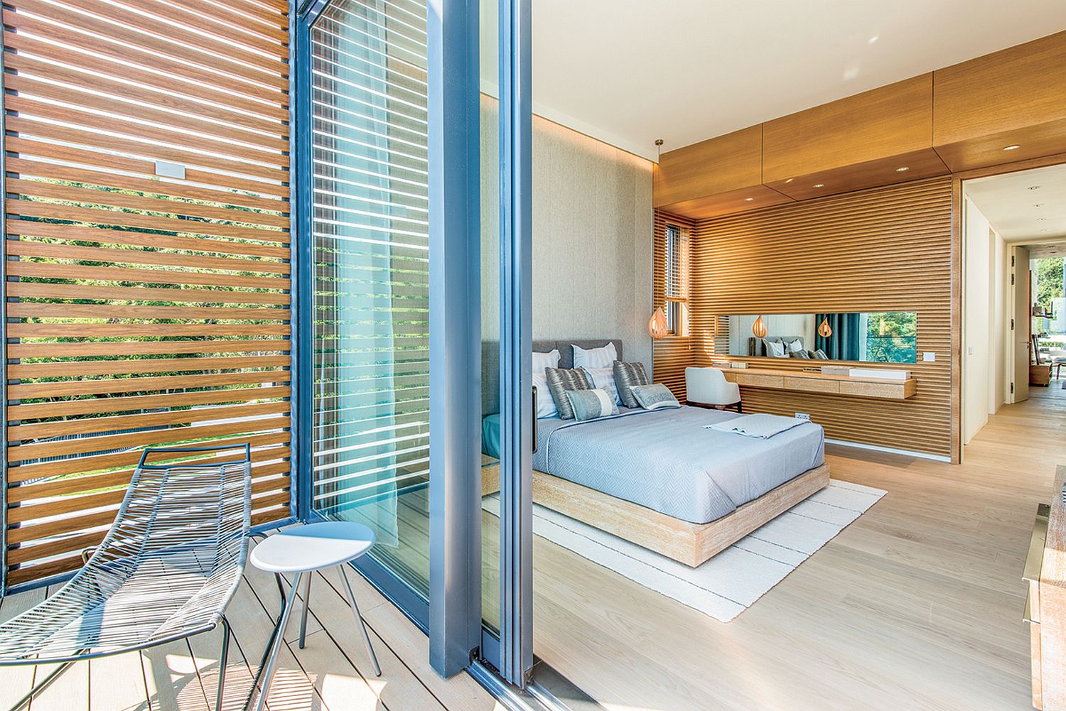 Sliding glass doors connect the master bedroom with the balcony outside