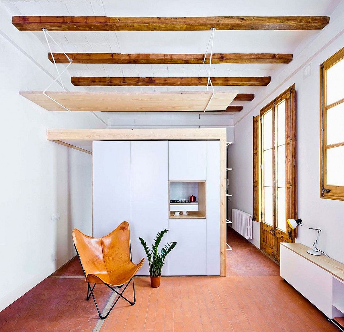 This tiny apartment kitchen has a mezzanine level of its own