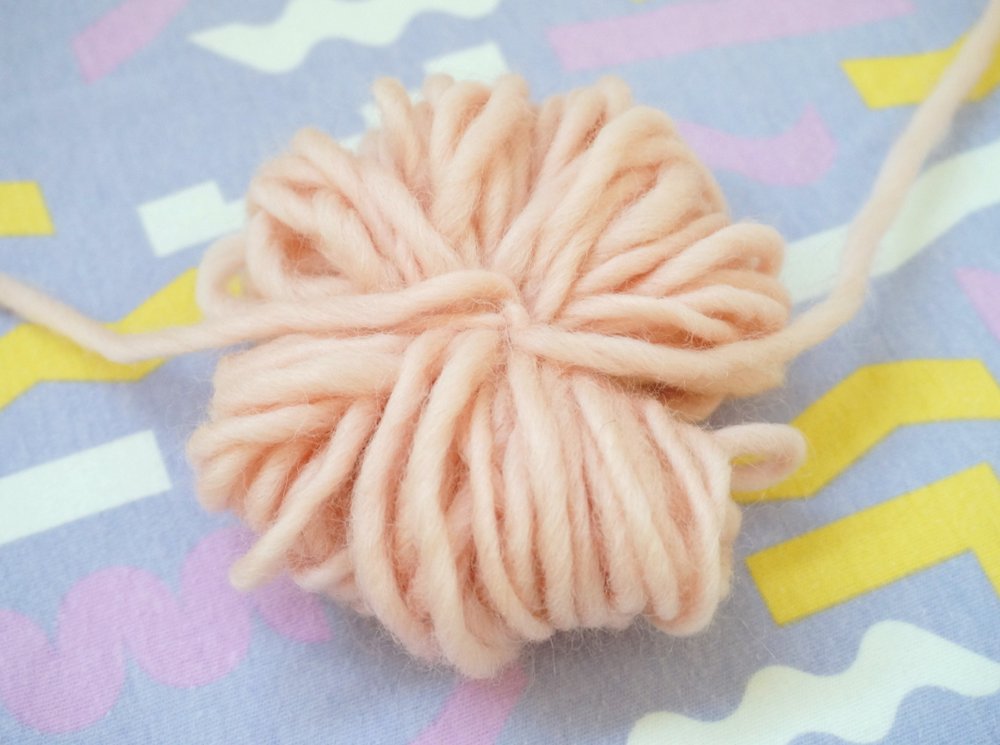 Tie a piece of yarn around the middle
