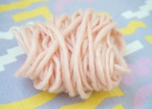 Wrap-the-yarn-around-your-hand-to-form-a-cluster-217x155