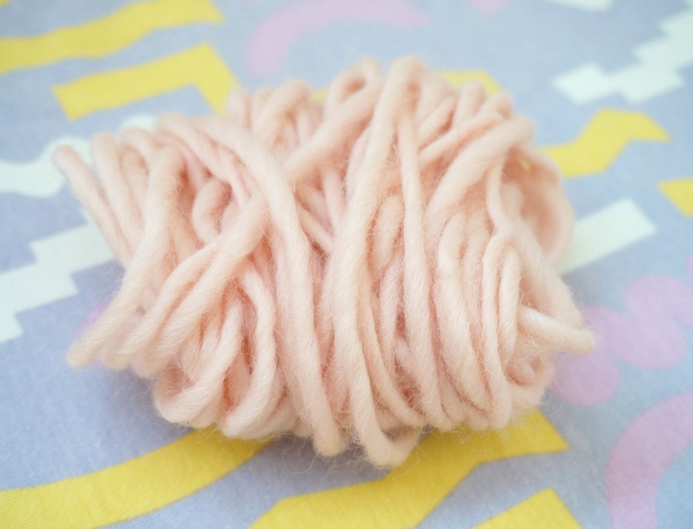 Wrap the yarn around your hand to form a cluster