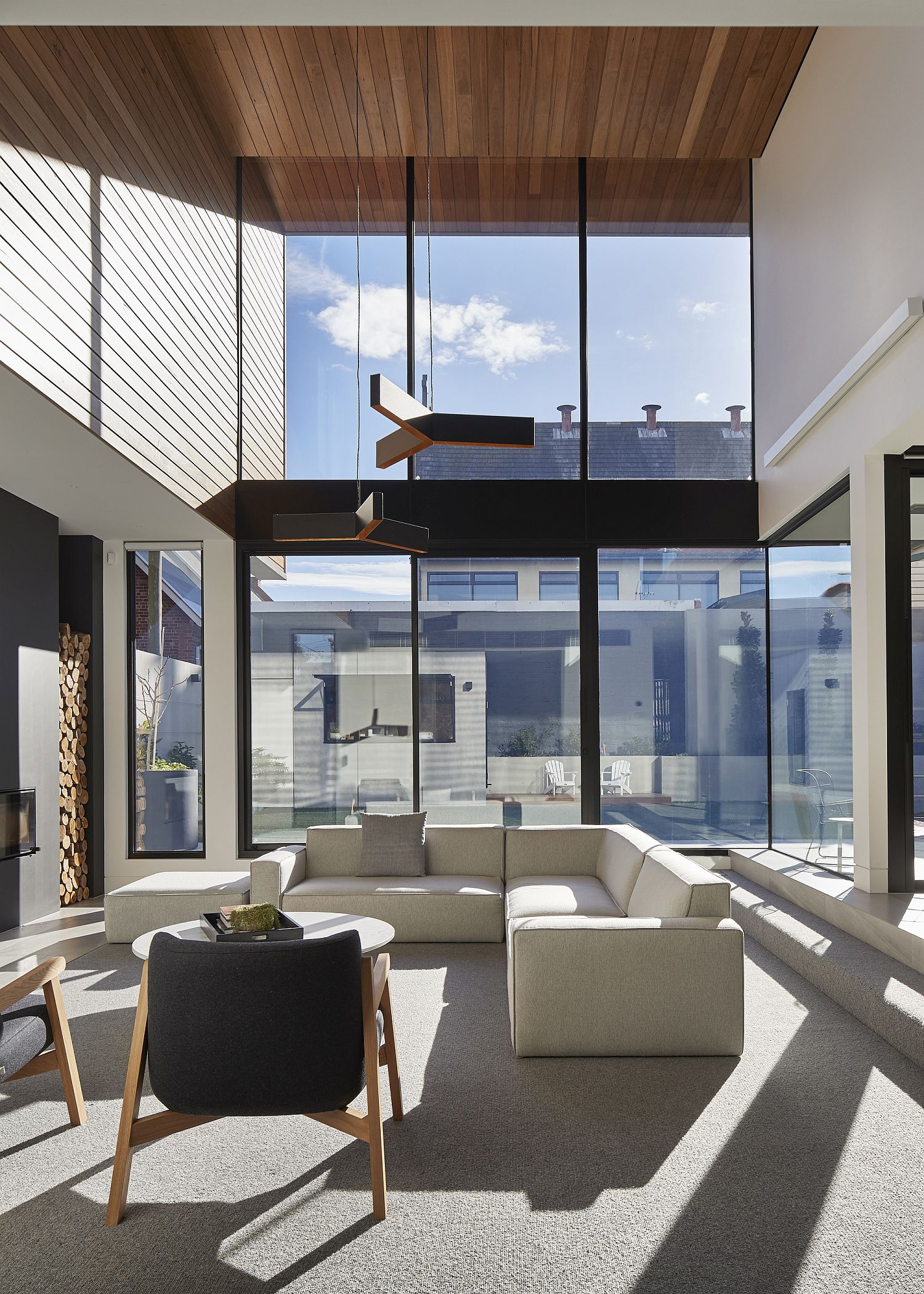 Dark metallic frame, glass windows and a wooden roof give the interior a unique look