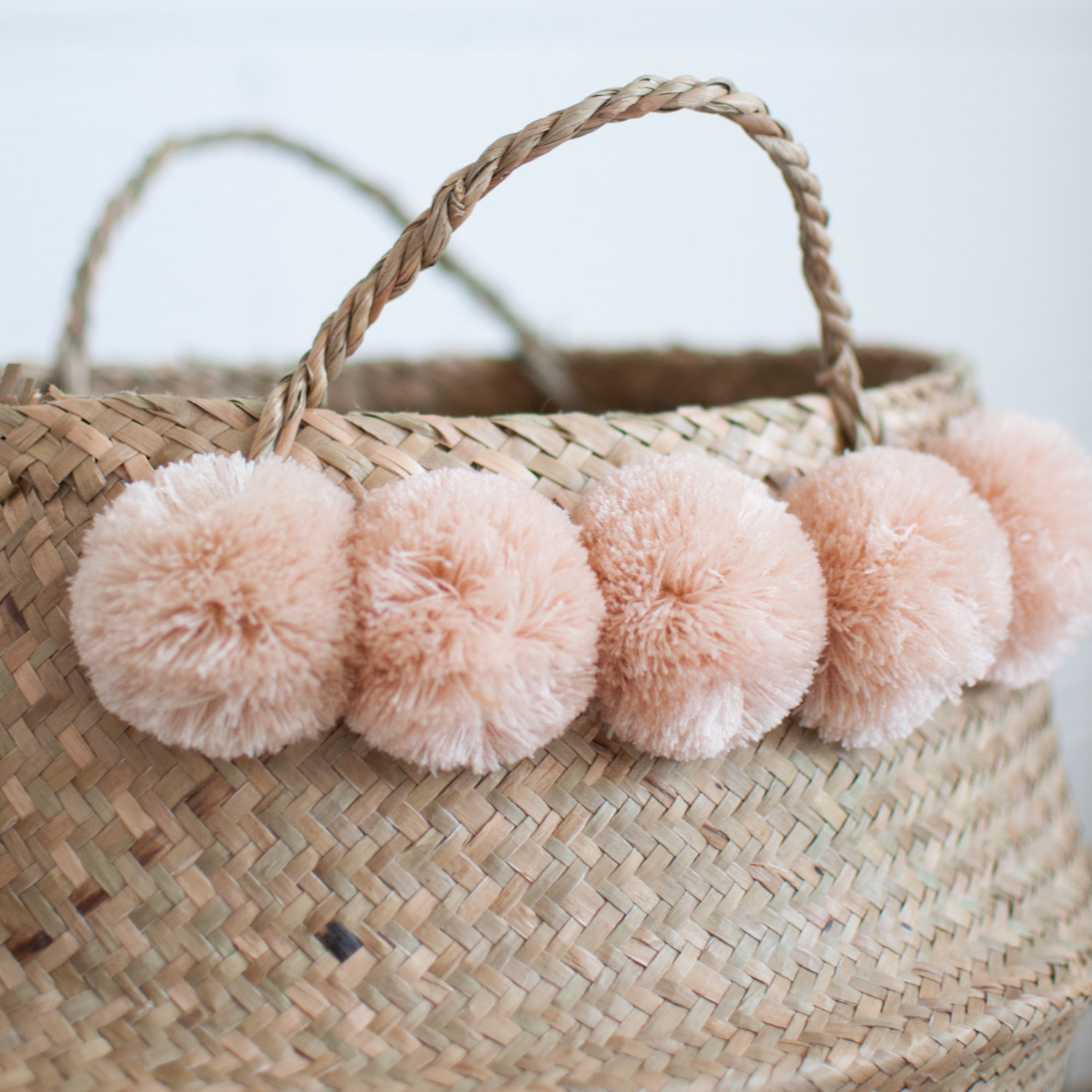 Seagrass basket with blush pom poms from Xinh &amp; Co.