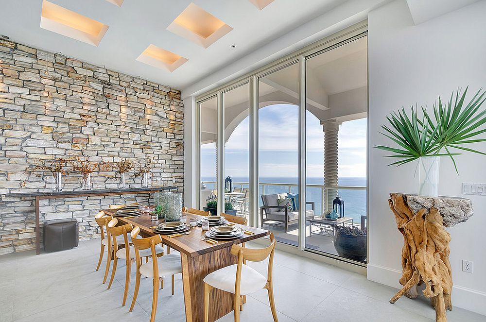 Amazing blend of minimalism with traditional stone wall in the dining room