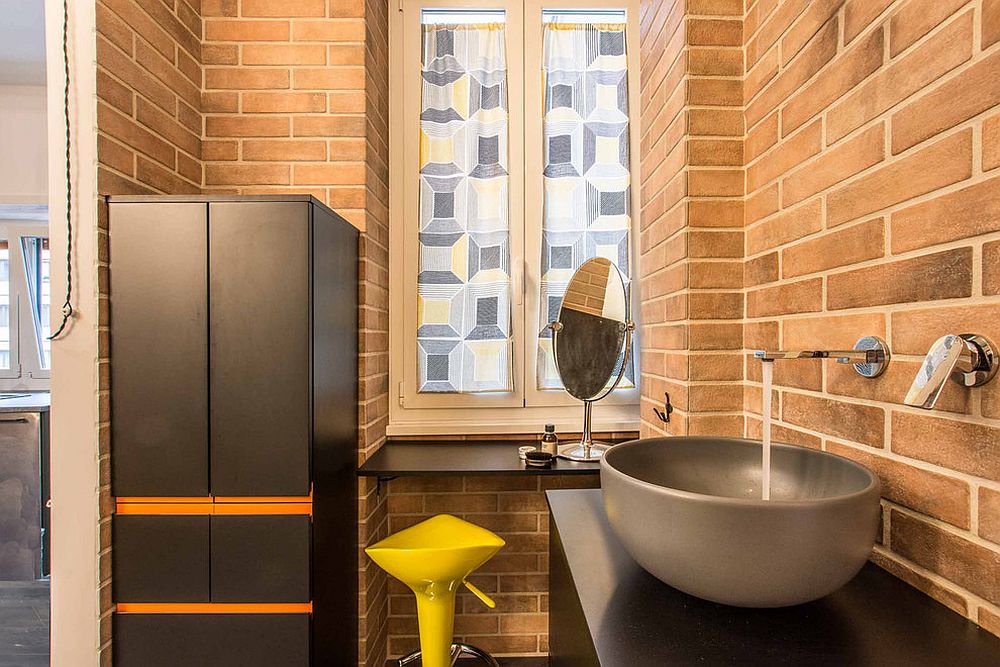 Brick walls give a lovely orange patina to this industrial bathroom