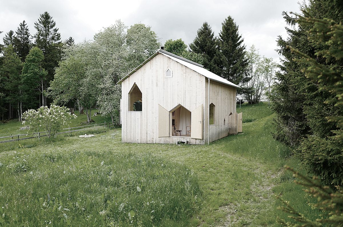 Lovely-use-of-windows-creates-a-charming-little-wooden-house-in-Switzerland