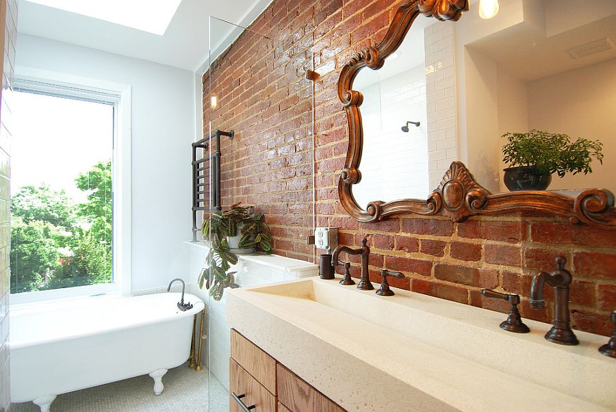 Mirror frame adds to the classic appeal of this bathroom with brick and glass walls