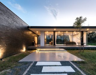 This Open Thai Home with Glass Walls is Encircled by a Flower Garden