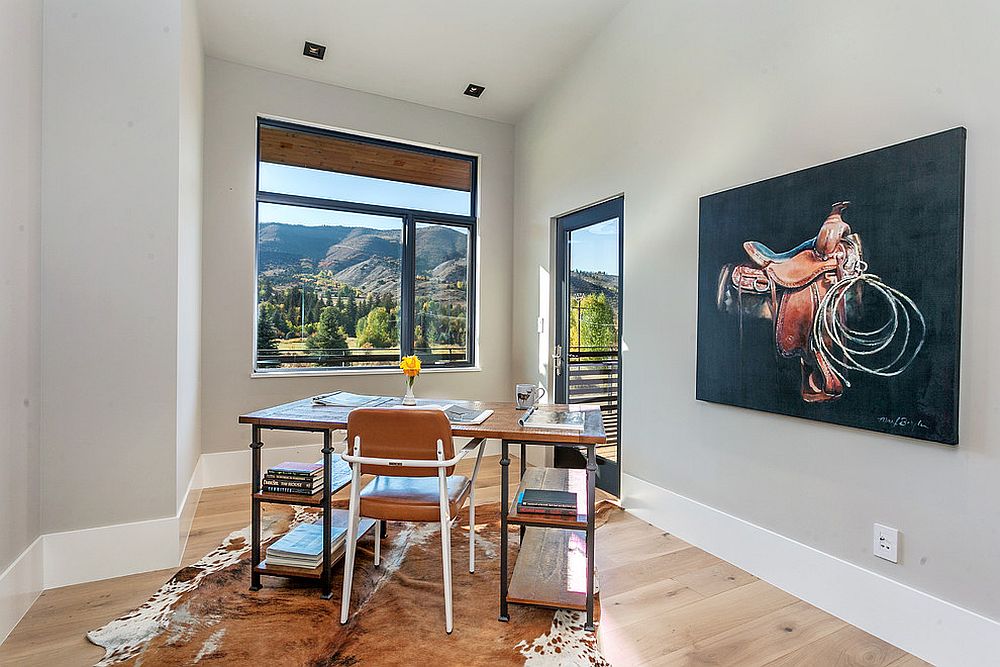 Small window and a spacious balcony bring mountain views into this modern home office in gray