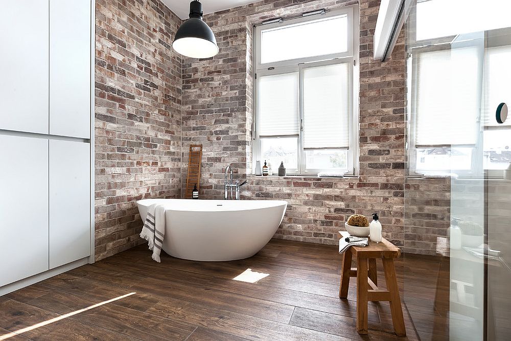 Weathered brick walls look stunning in the industrial style bathroom