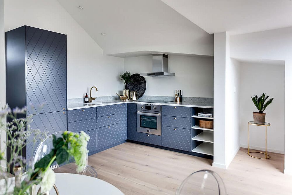 Brilliant blue patterened cabinets shape this brilliant corner kitchen inside the Scandinavian apartment