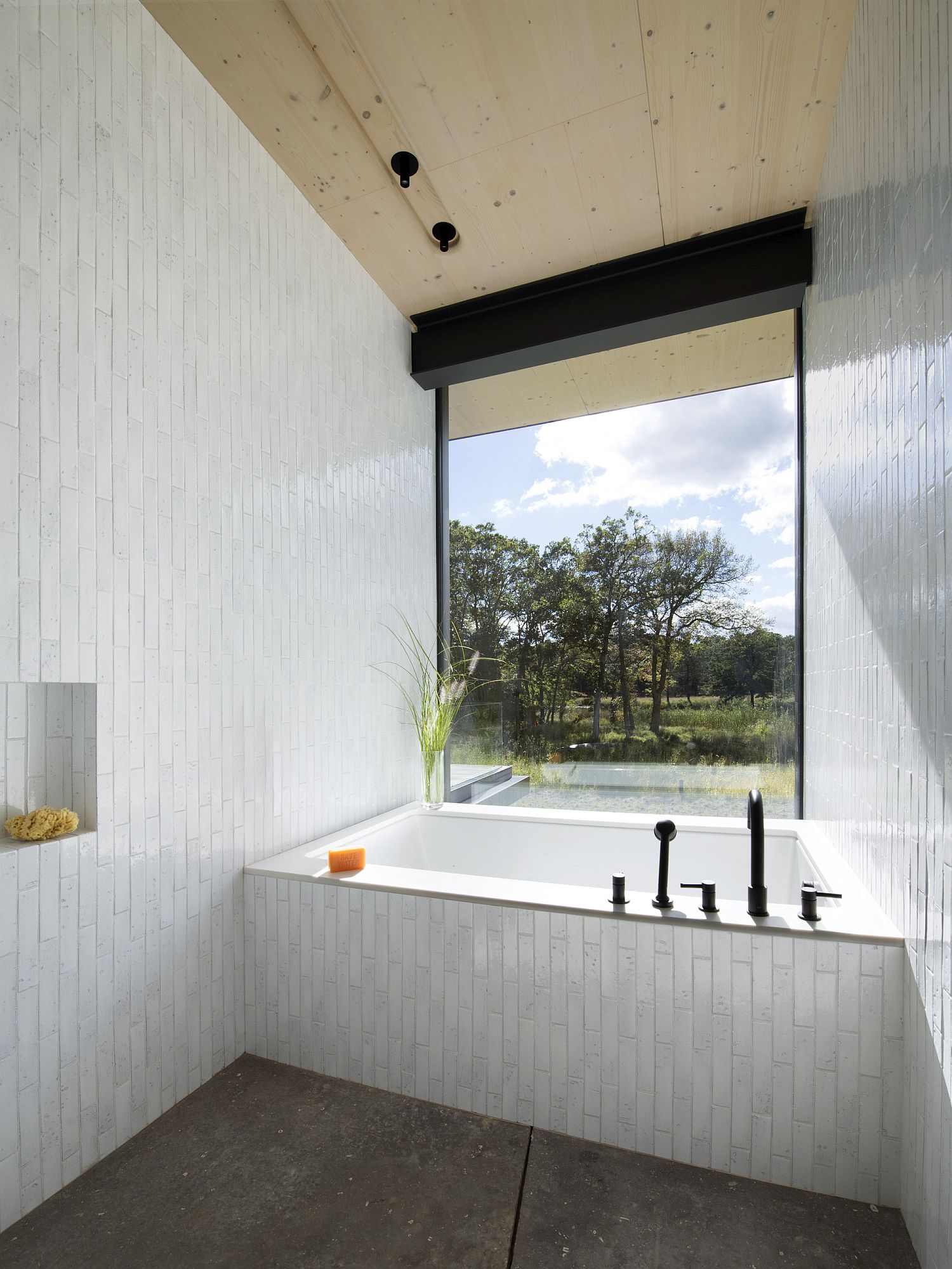 Contemporary tiled bathroom with a large window