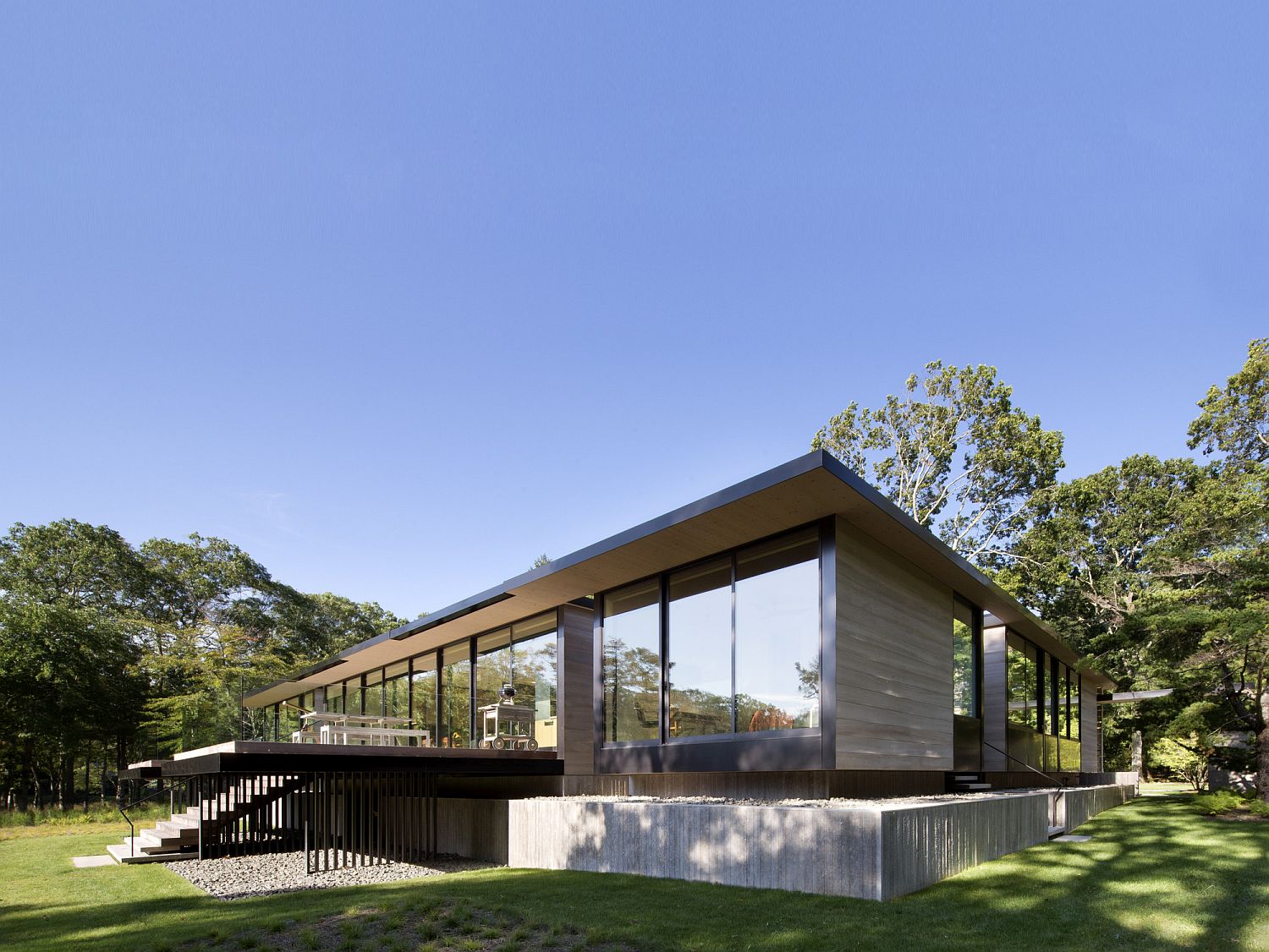 Different terraces and surfaces around the elevated house provide smart outdoor spaces