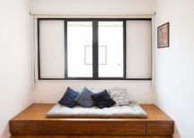 Elevated-platform-next-to-the-window-provides-great-space-for-a-minimal-bed-217x155
