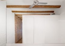 Modern-bathroom-and-WC-in-white-with-wooden-ceiling-beams-above-217x155