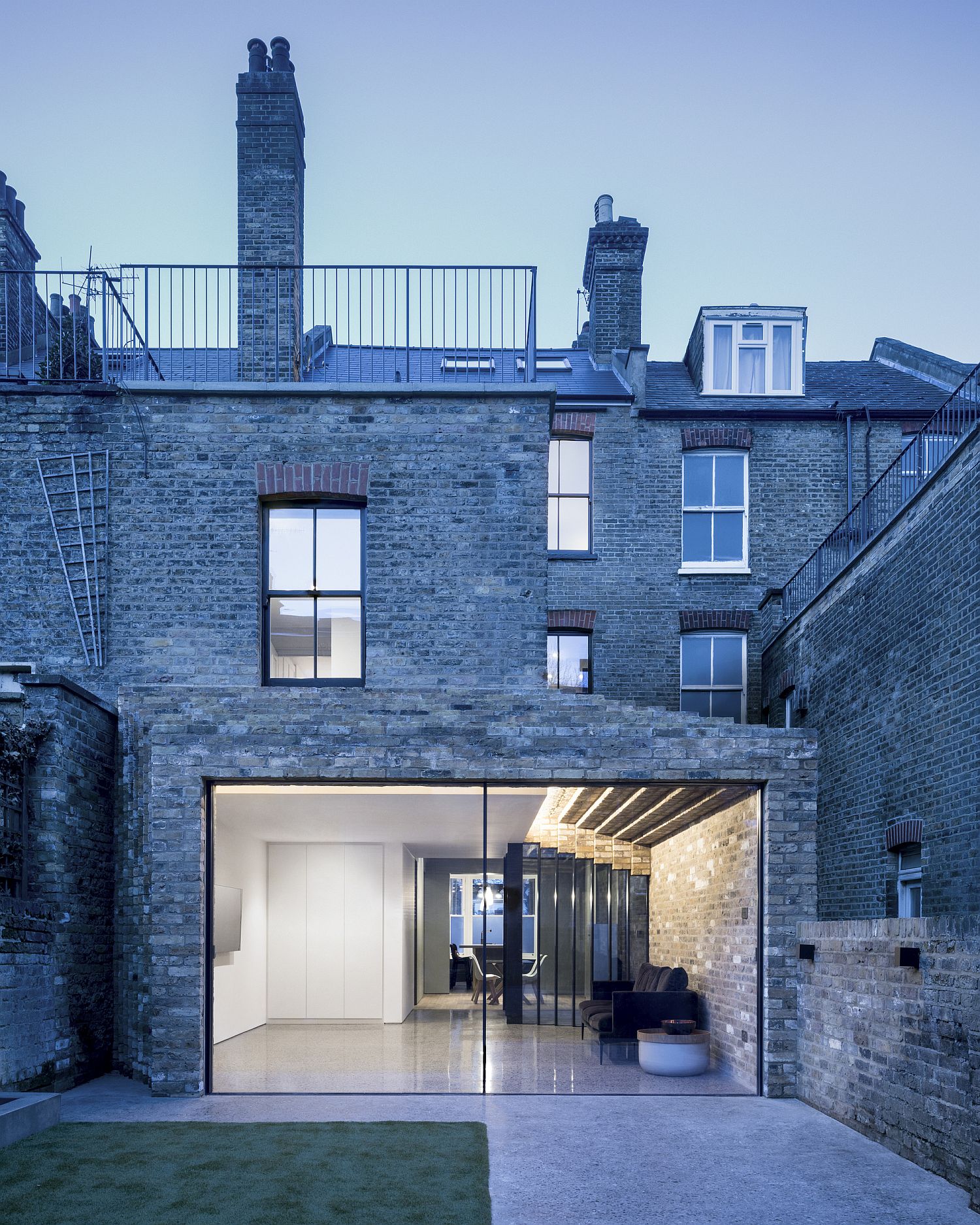 Modern brick extension to the classic London home blends into its historic form