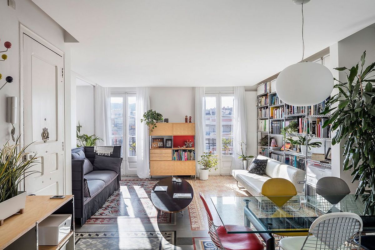 Modest living room of revamped Barcelona apartment filled with classic decor pieces