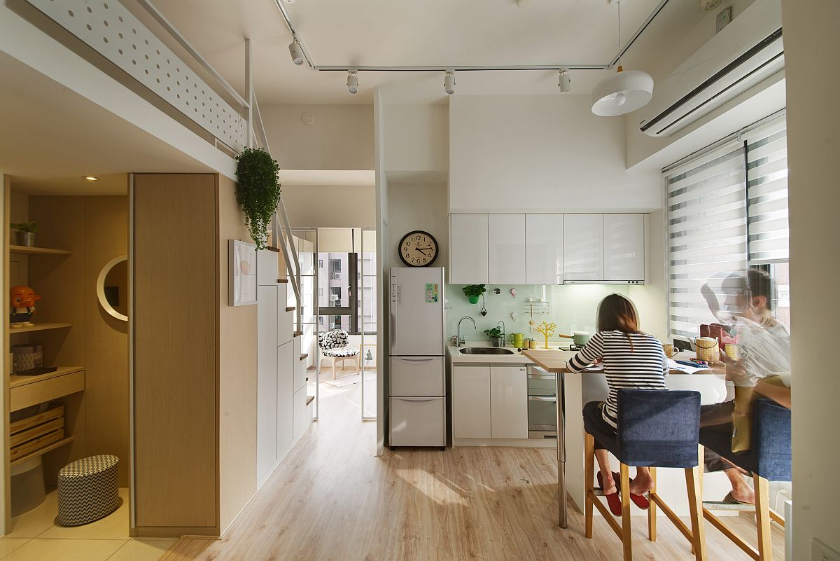 Open plan living brings together kitchen and dining inside the small apartment