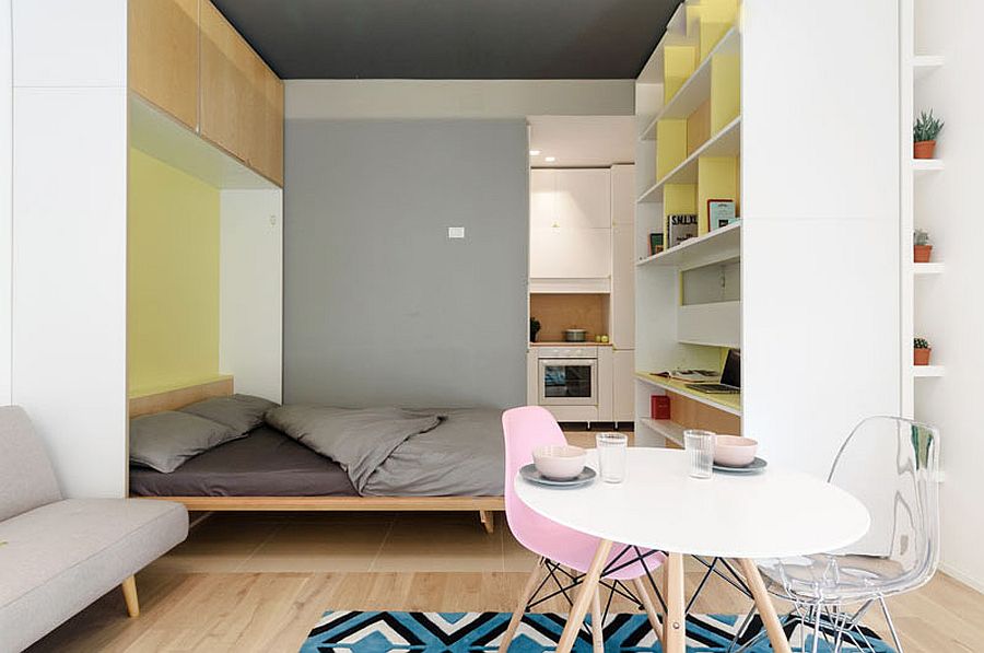 Pastel-filled-living-room-of-micro-apartment-comes-with-a-Murphy-bed-niche-as-well