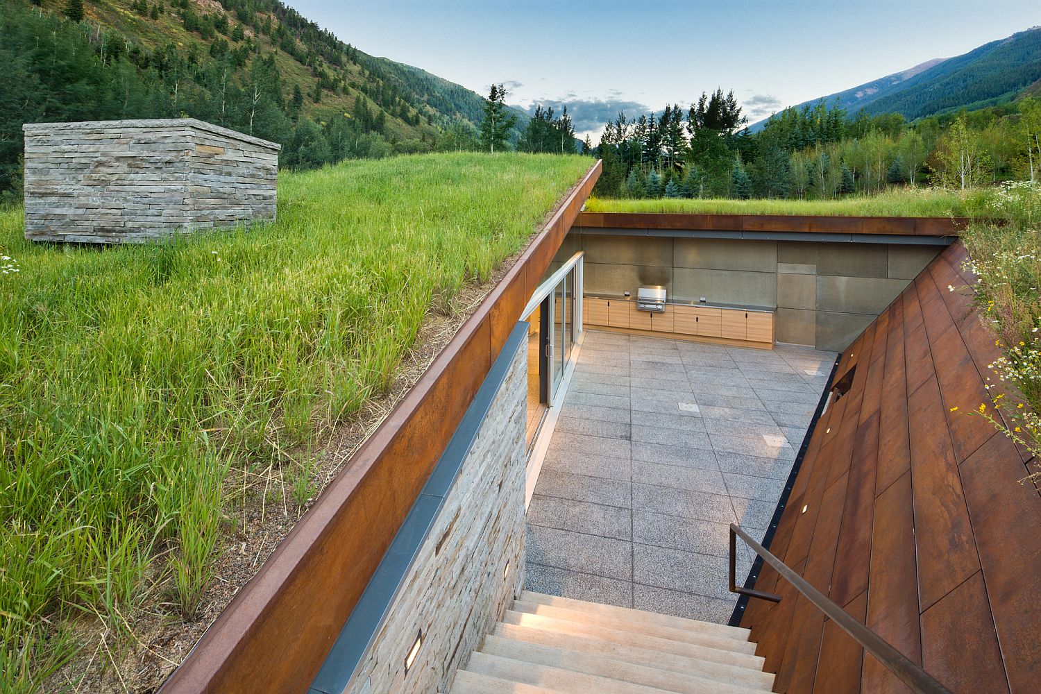 Private sunken outdoor space surrounded by corten clad walls