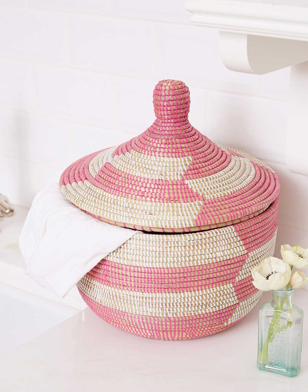 Rose herringbone basket on a powder room counter