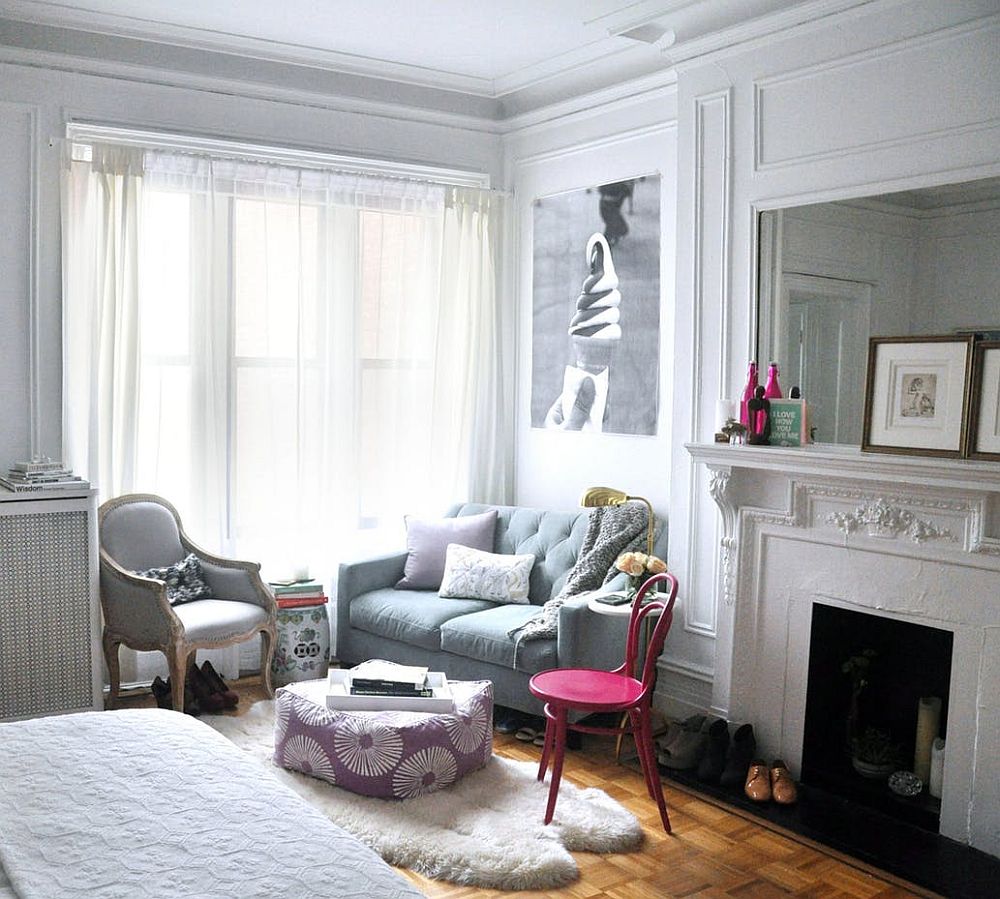 Shabby chic living space of tiny apartment with pops of pink