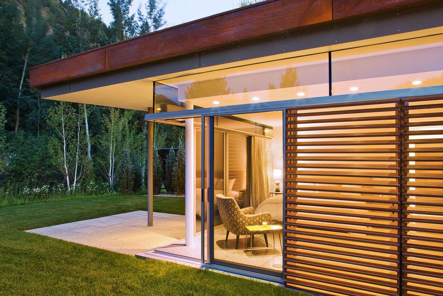 Shutters and glass doors are used cleverly to create balance between privacy and lovely views
