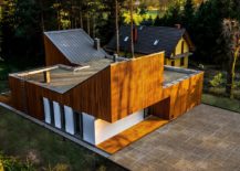 Sloped-roofs-and-wooden-cladding-of-the-home-gives-it-a-unique-look-217x155