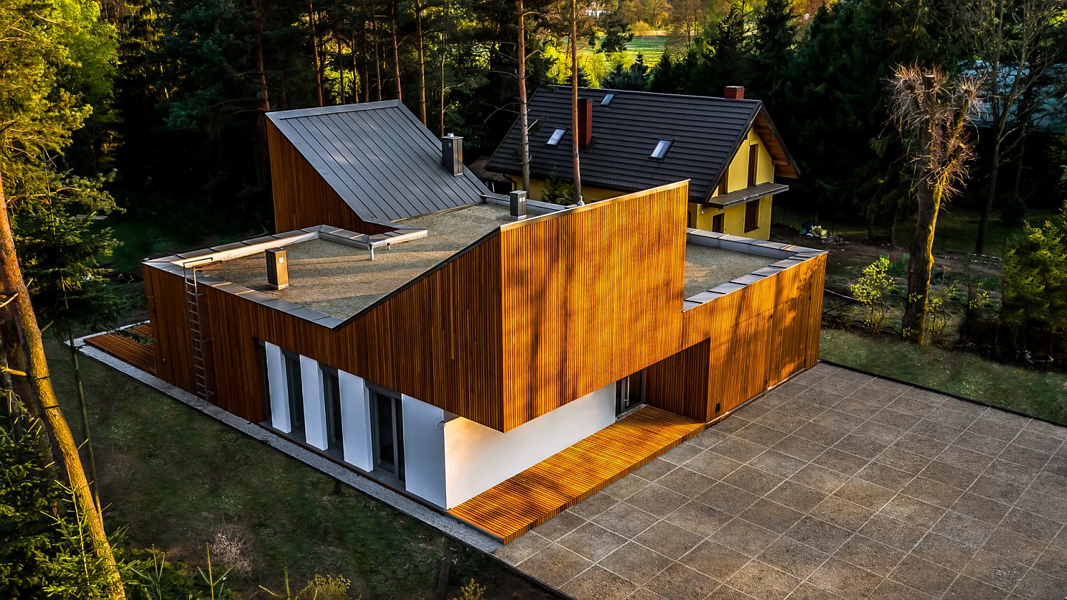 Sloped roofs and wooden cladding of the home gives it a unique look