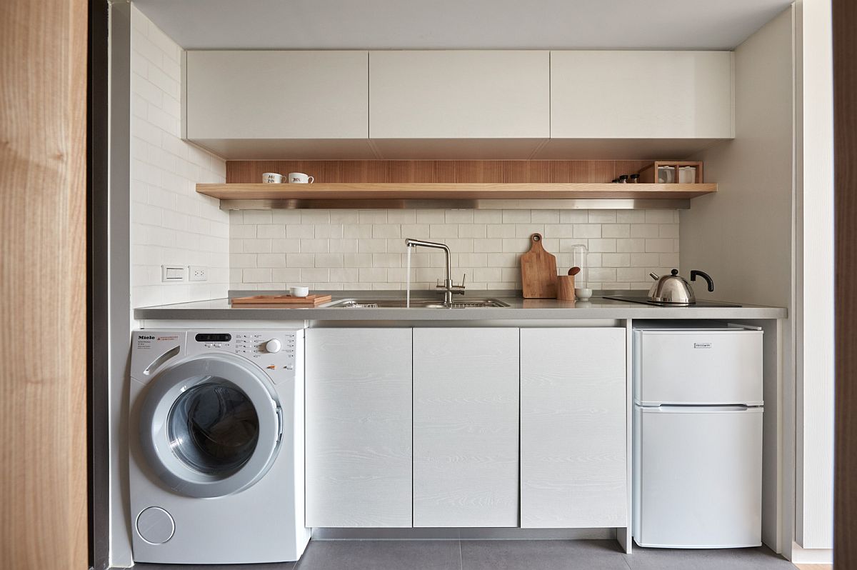 apartment kitchen countertop with built-in washing machine.