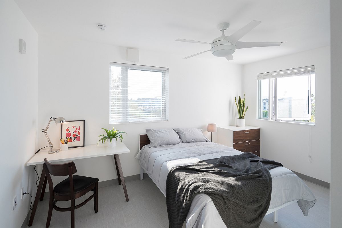 White bedroom inside the apartment unit with ample natural light
