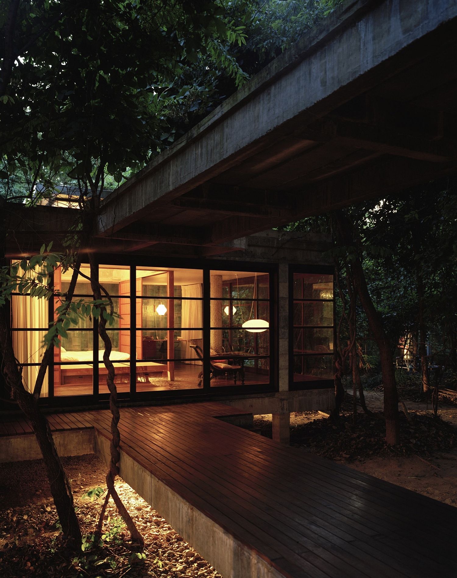 An elevated deck and covered walkways connect different rooms of the house
