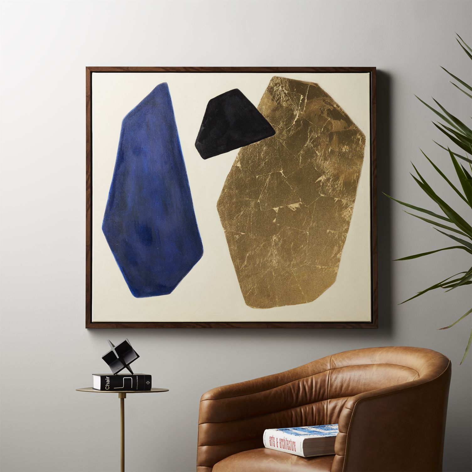 Brown leather chair and modern art from CB2