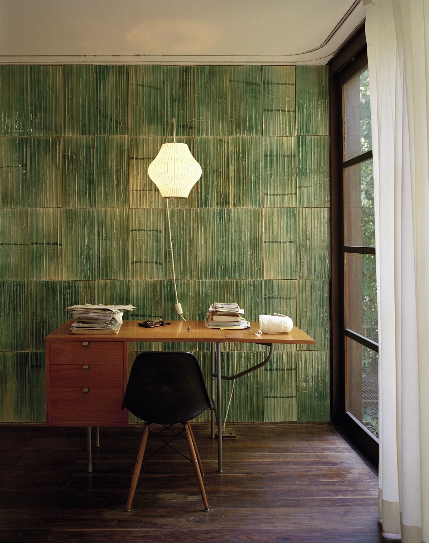 Custom green tiles on the wall add ro the Asian style of the interior