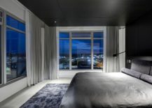 Dark-wooden-ceiling-stands-in-contrast-to-the-walls-in-white-in-the-bedroom-217x155