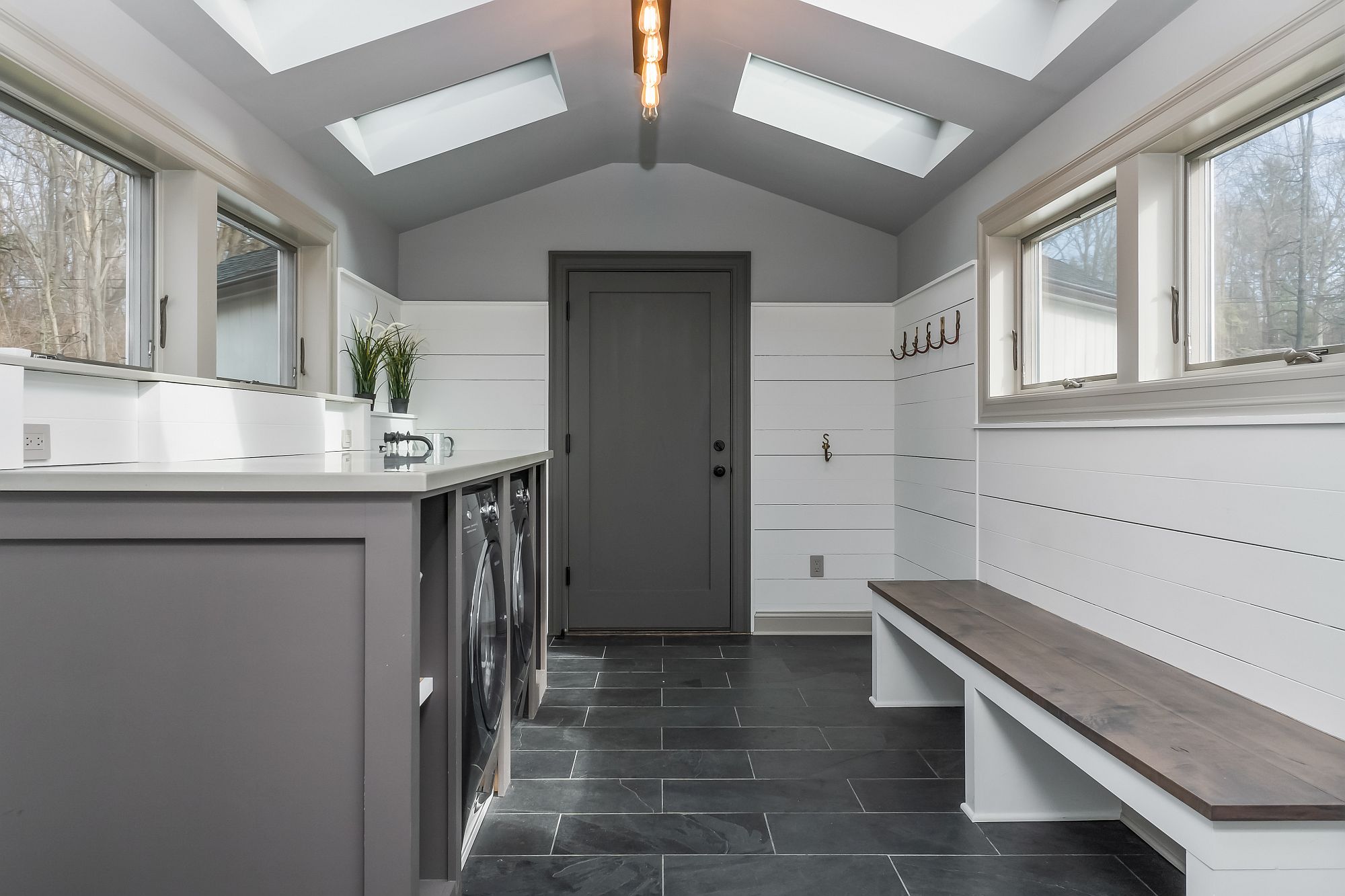 Laundry area and mud room in white and gray for the modern home
