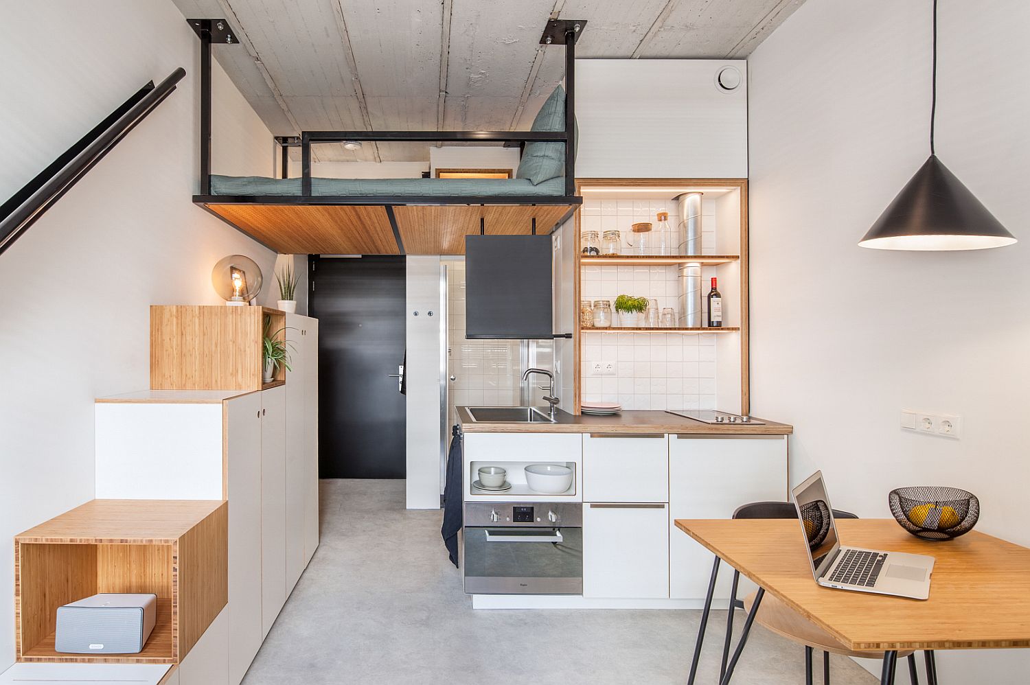 Look-at-the-loft-bedroom-inside-the-18-sqm-apartment-with-wooden-steps-that-double-as-storage-units