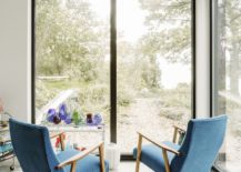 Lovely-little-conversation-nook-with-large-glass-walls-and-bright-blue-chairs-217x155
