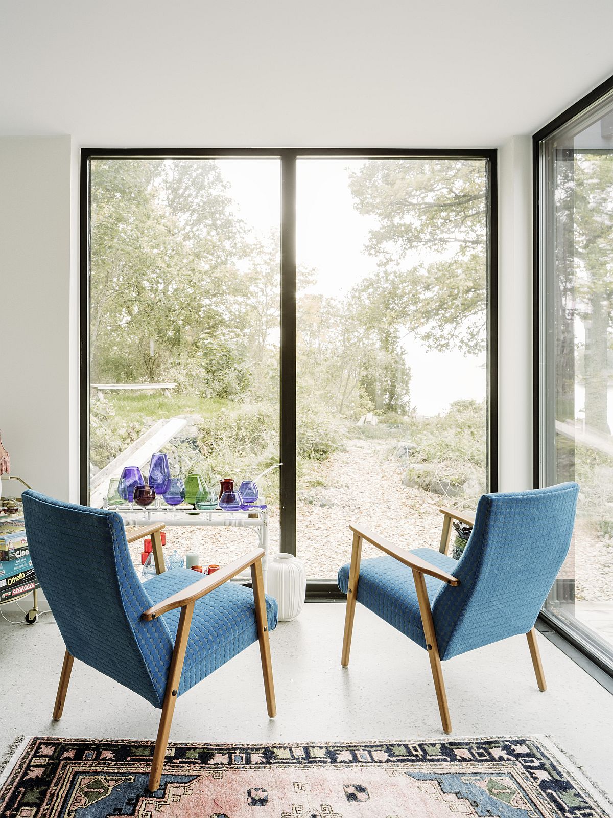 Lovely little conversation nook with large glass walls and bright blue chairs