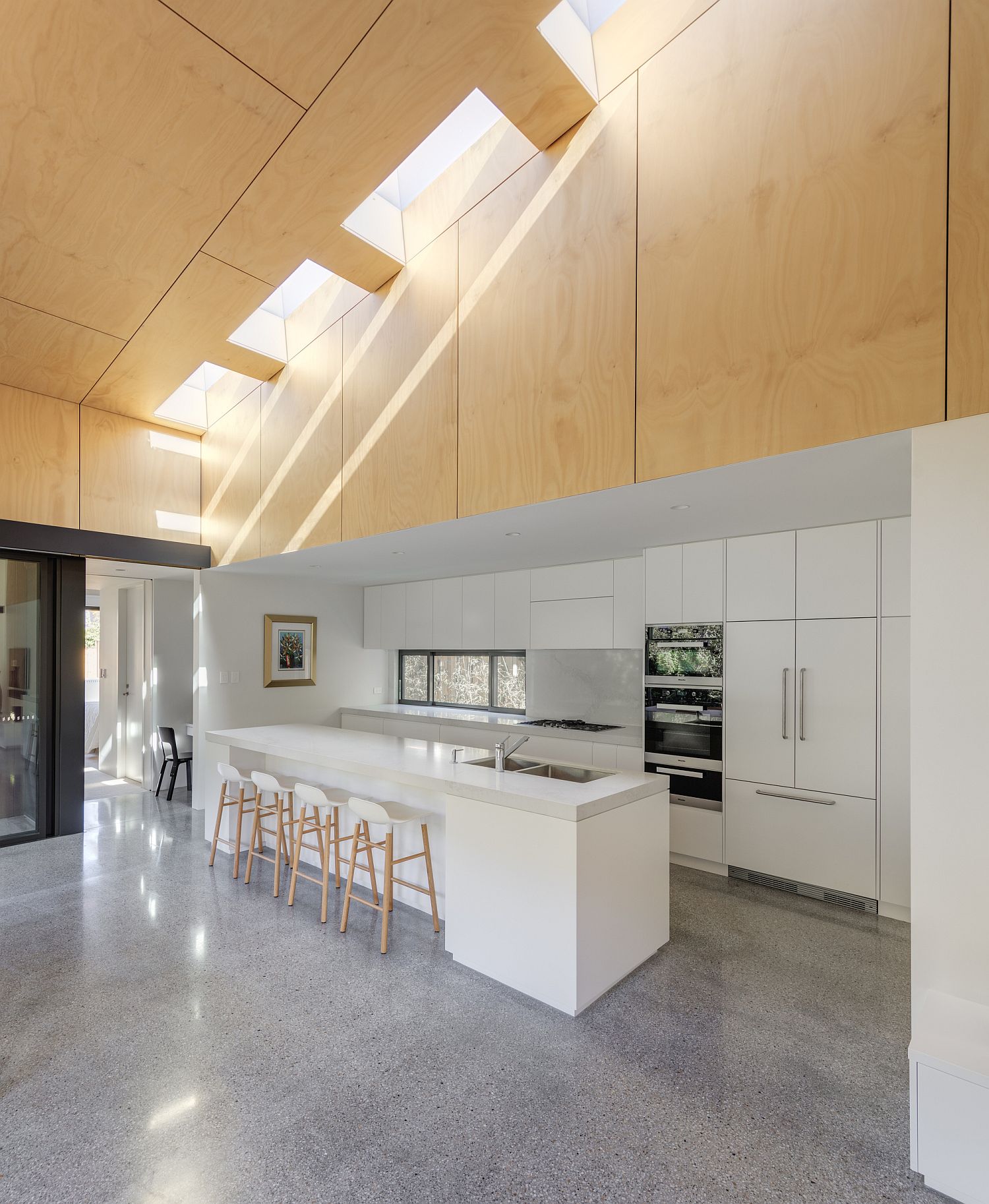 Smart placement of ventilation duct illuminates the lower level kitchen and dining area