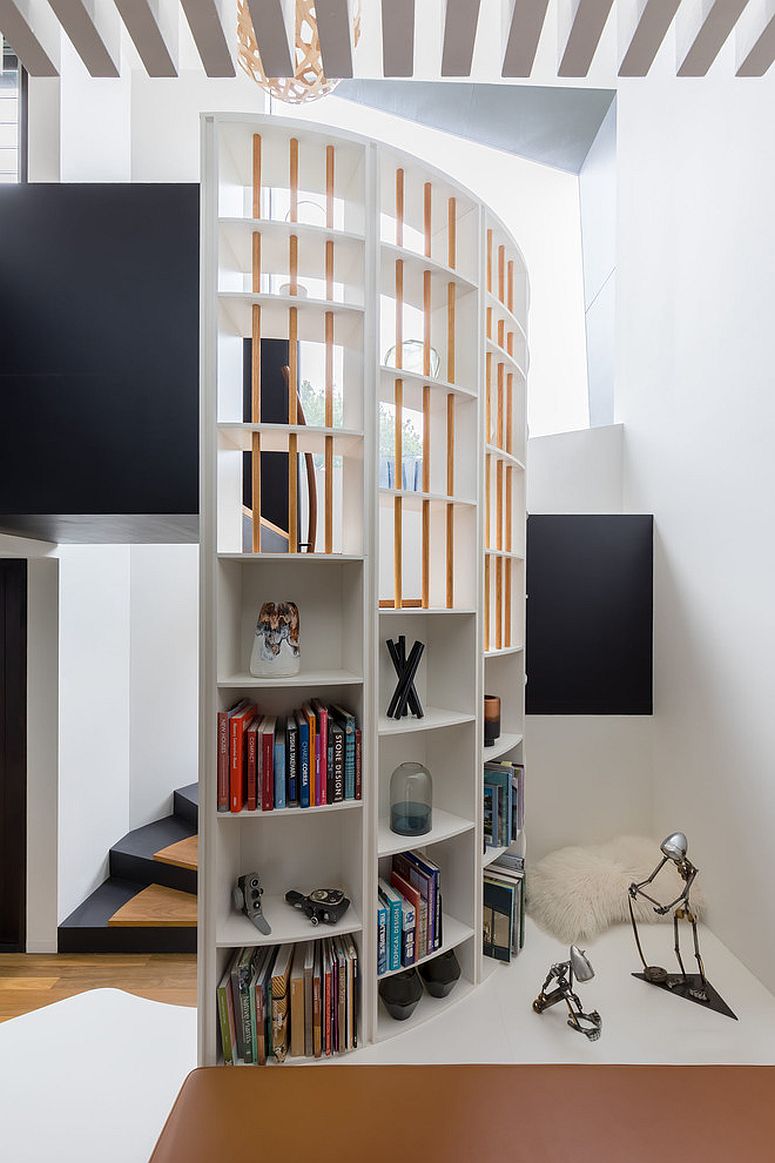 Spiral staircase can also add addition shelf space to the living room