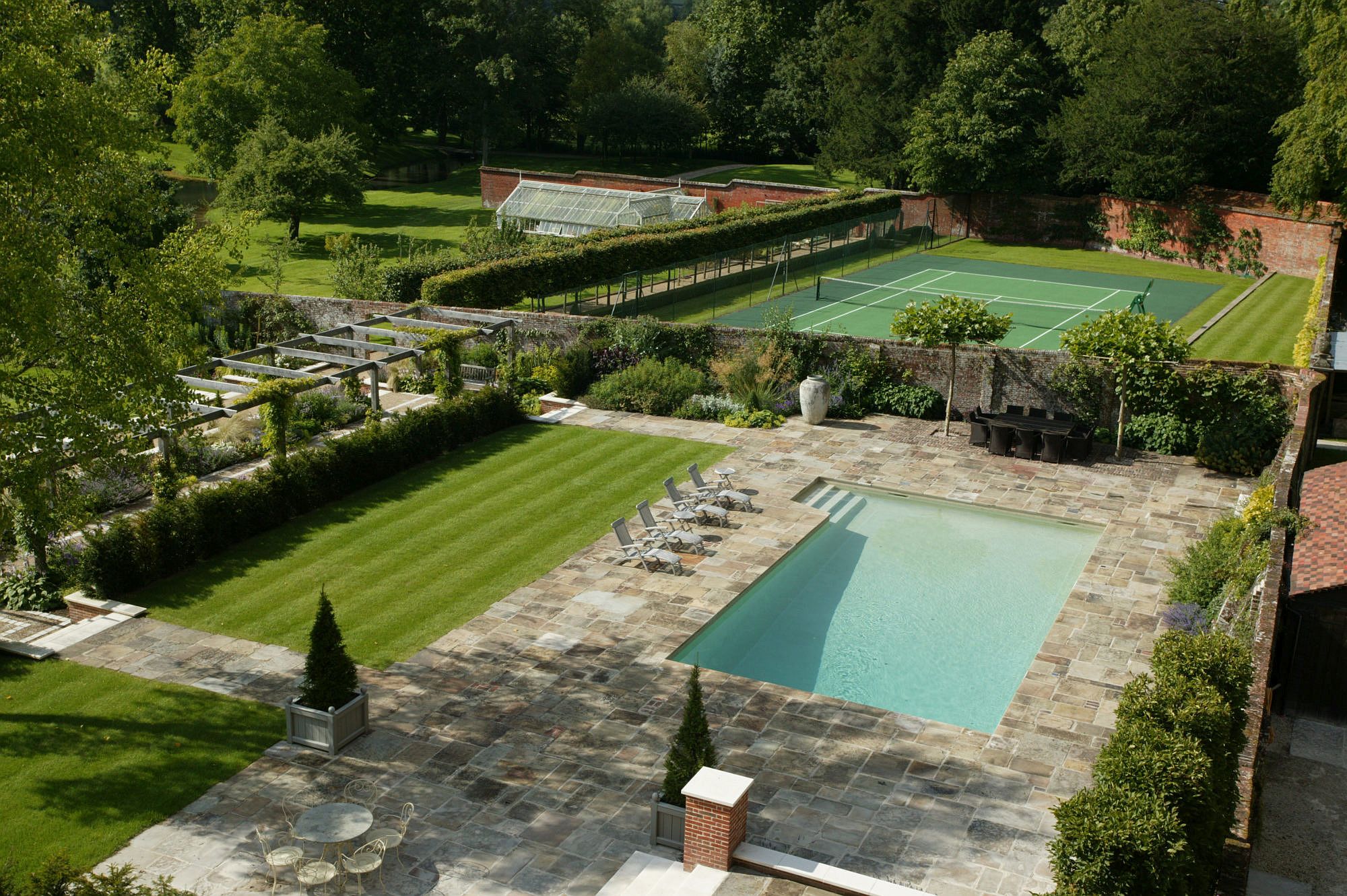 Tennis court and swimming pool are a part of the expansive gardens around the Manor House