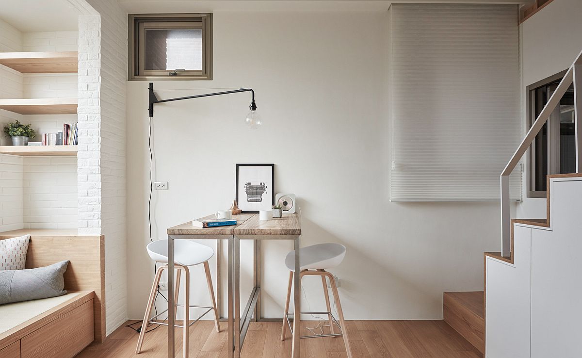 Tiny table in the apartment is used as both work table and dining table