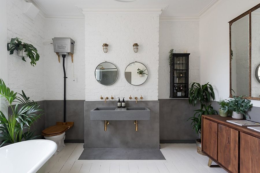 Whitewashed brick walls coupled with concrete inside the spacious contemporary bathroom