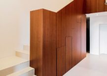 Wooden-staircase-wall-morphs-to-offer-smart-and-hidden-storage-underneath-217x155